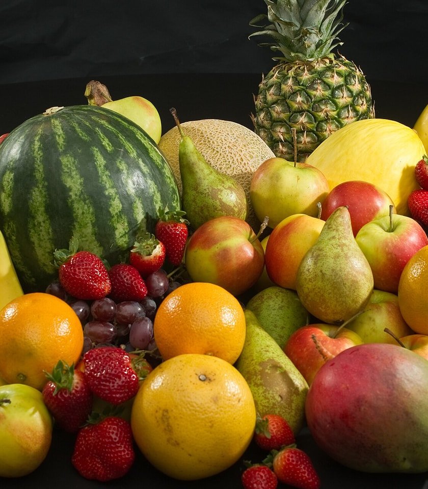 Premium assorted fresh fruits arranged in a wooden bowl